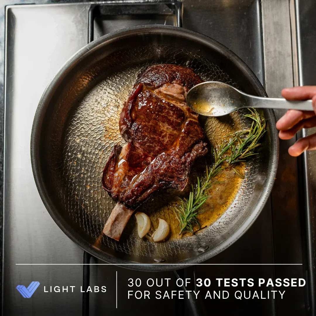 Kaizen pan with steak and a promotional badge